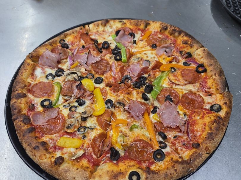 The Supreme — Ham · pepperoni · peppers · olives · mushrooms at Rihana's Pizza & Wings, North Phoenix