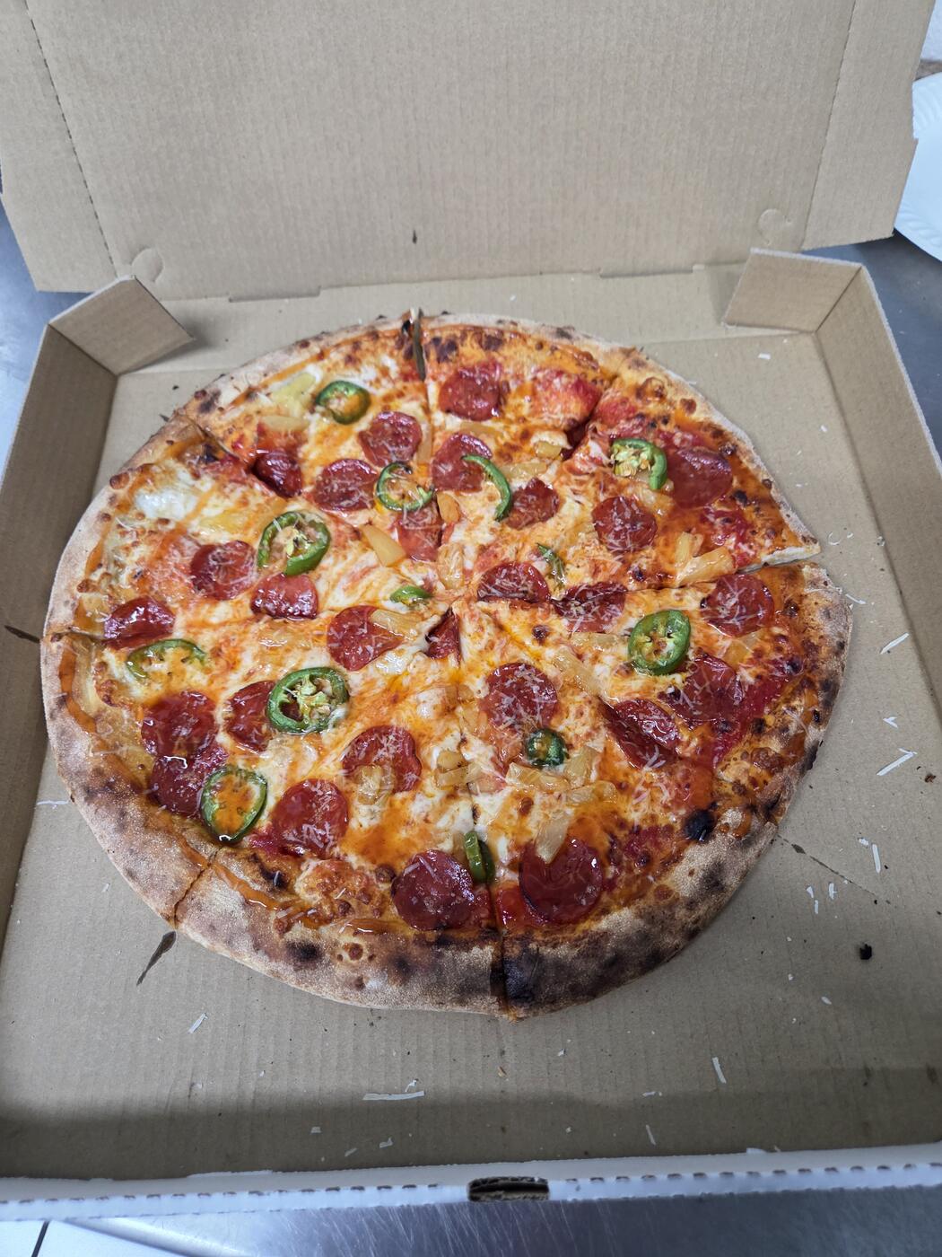 Pepperoni pizza with jalapeño and pineapple