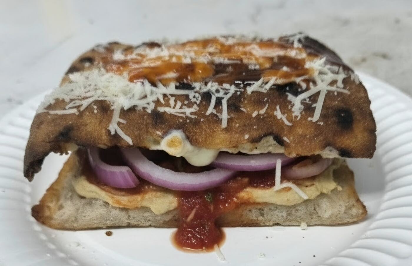 Rihana Roll with red onion, red sauce, and cheese