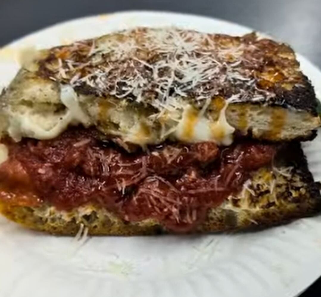 Rihana Roll with red sauce, melted cheese, and shredded cheese