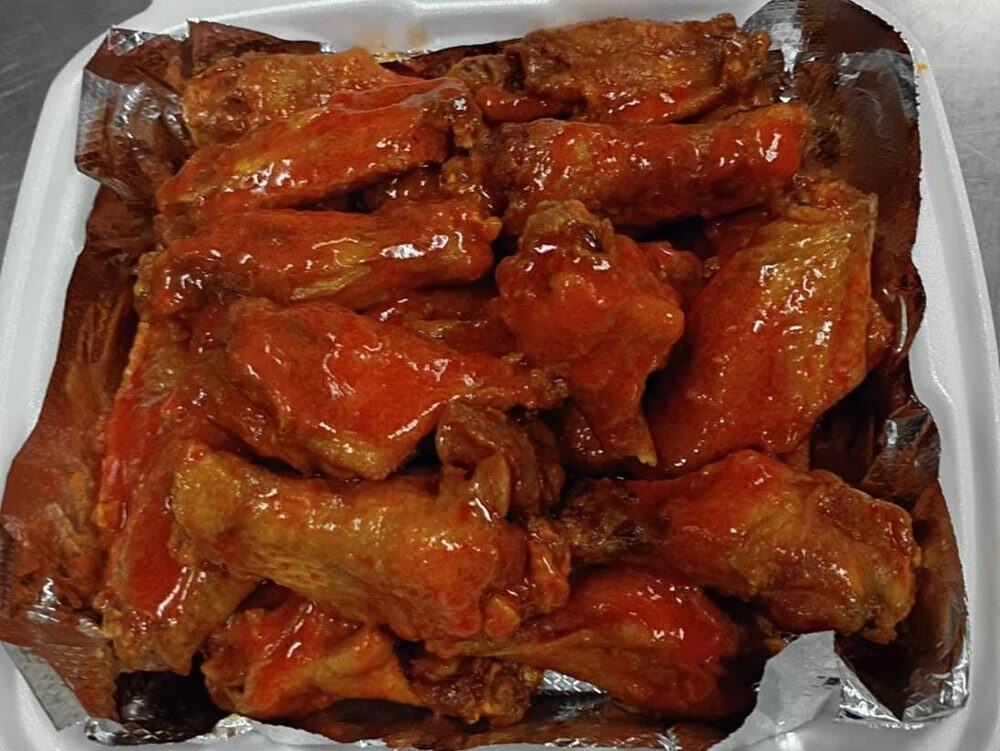 Wings tossed in a glossy red sauce